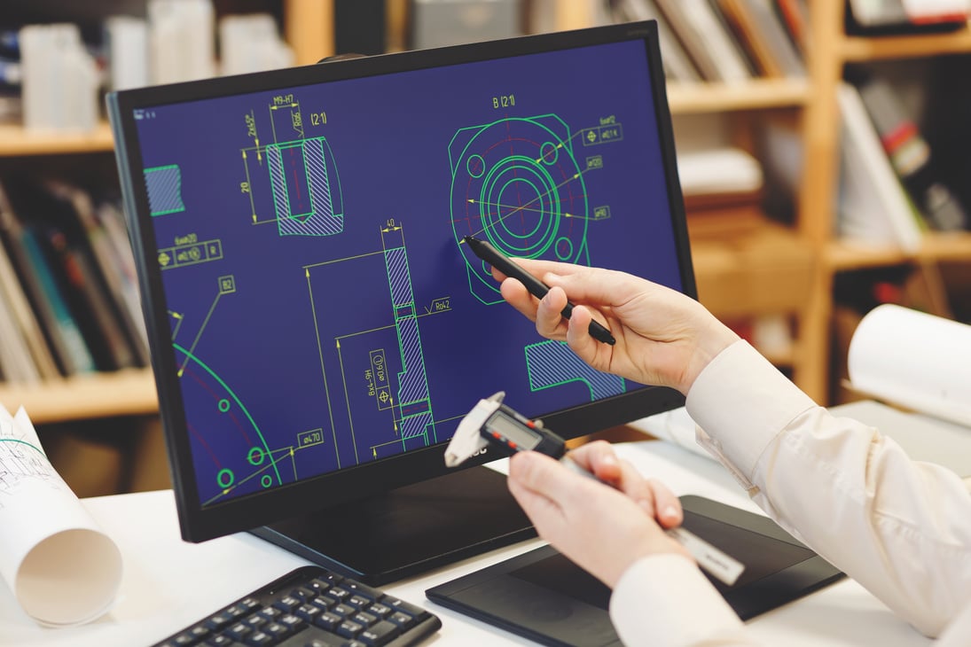 Engineer working on cad scheme using computer tools.